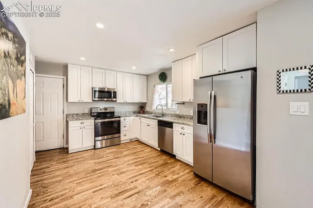 a kitchen with stainless steel appliances a refrigerator sink and microwave