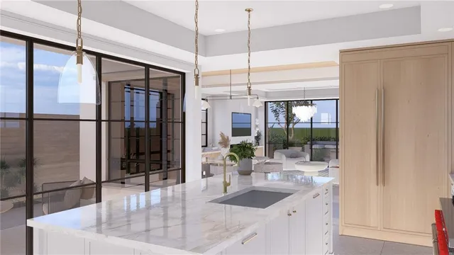 a kitchen with stainless steel appliances granite countertop a refrigerator a oven and a sink with wooden floor