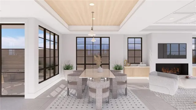 a living room with furniture a fireplace and a floor to ceiling window