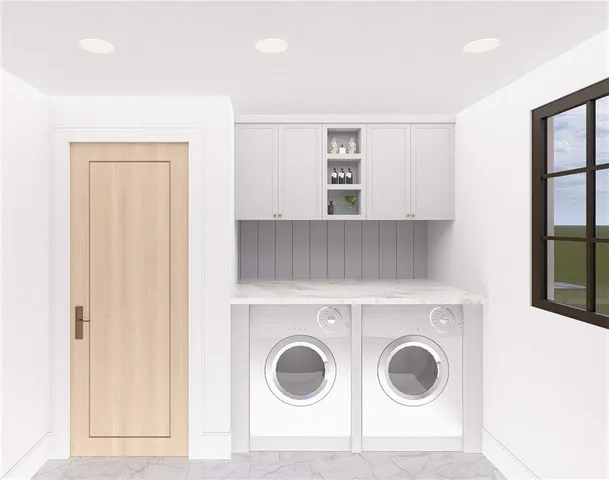 a view of washer and dryer with kitchen in the background