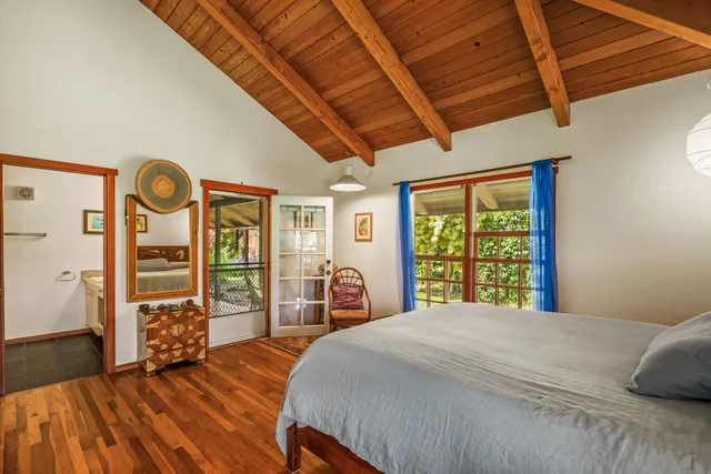 a bed room with a bed and a chair