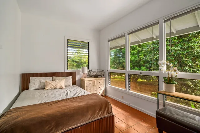 a bedroom with a bed and a couch