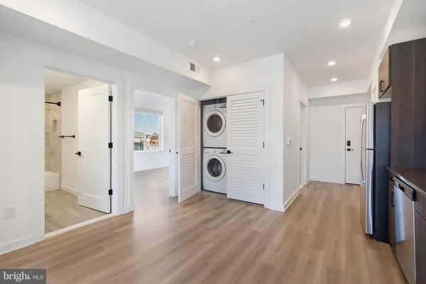 a view of a hallway with wooden floor