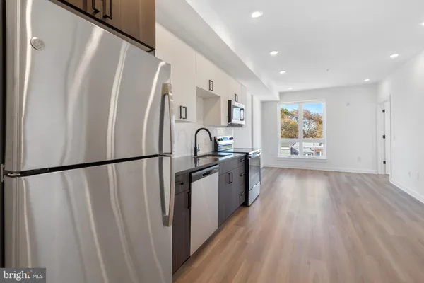 a view of a refrigerator in kitchen and wooden floor