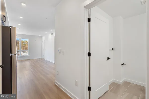 a view of a hallway with wooden floor