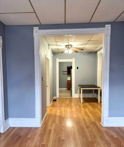 a view of a livingroom with wooden floor and furniture