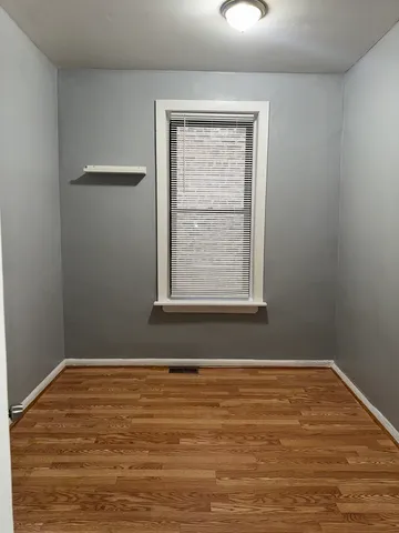 a view of a room with wooden floor and windows
