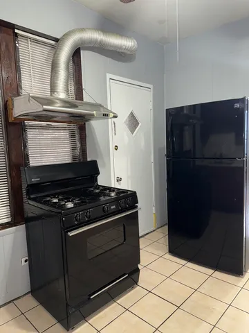 a stove top oven sitting inside of a kitchen
