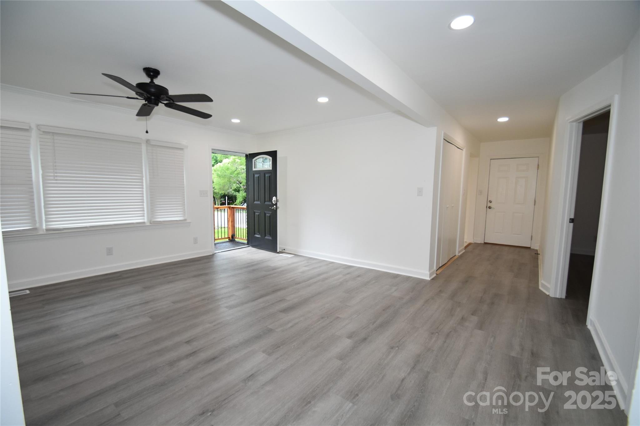 706 McIntyre Street Monroe, NC 28110 - Photo 12 of 20 an empty room with wooden floor and windows