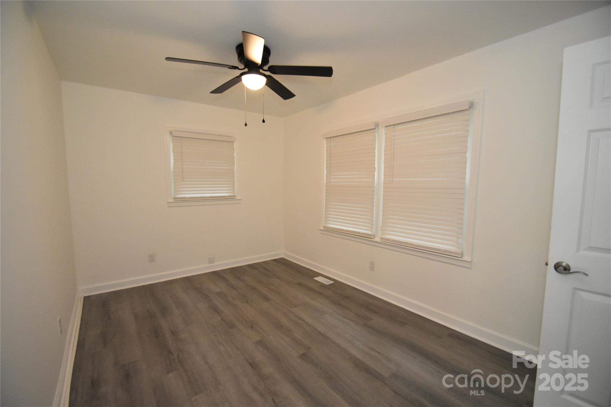 706 McIntyre Street Monroe, NC 28110 - Photo 14 of 20 a view of empty room with wooden floor and fan