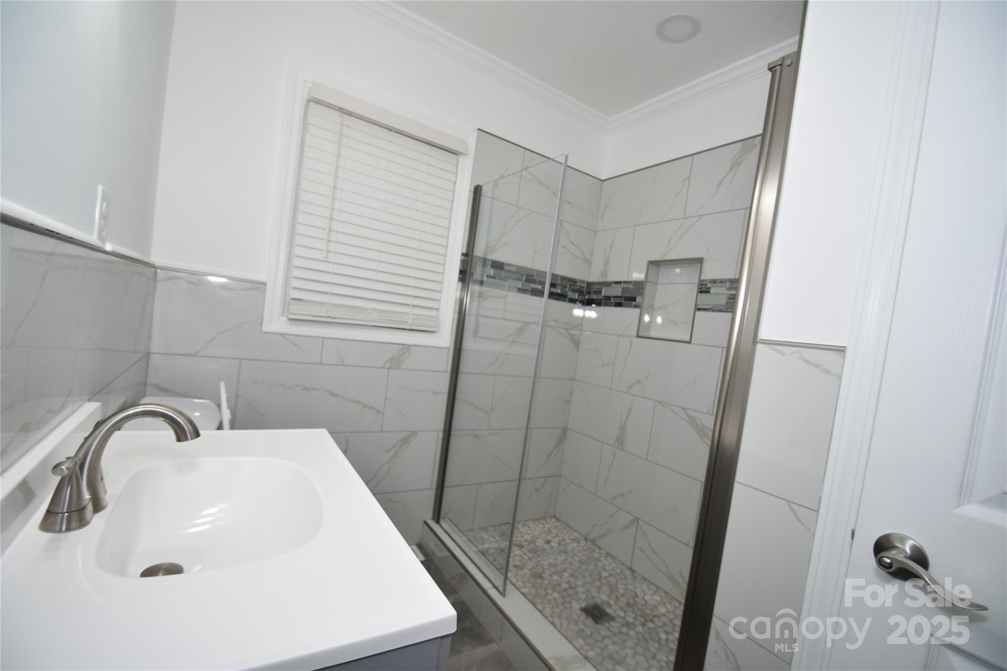 706 McIntyre Street Monroe, NC 28110 - Photo 15 of 20 a bathroom with a sink a mirror and shower