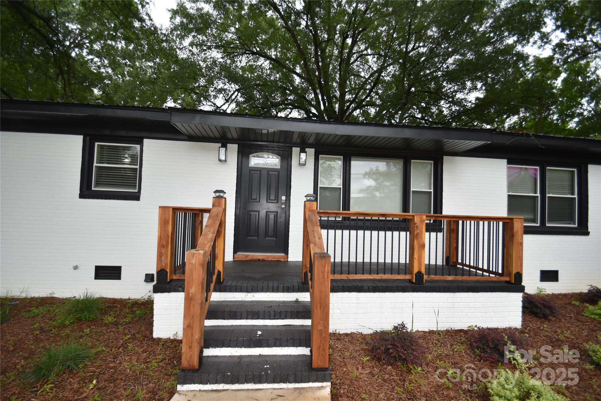 706 McIntyre Street Monroe, NC 28110 - Photo 18 of 20 a front view of a house with a yard