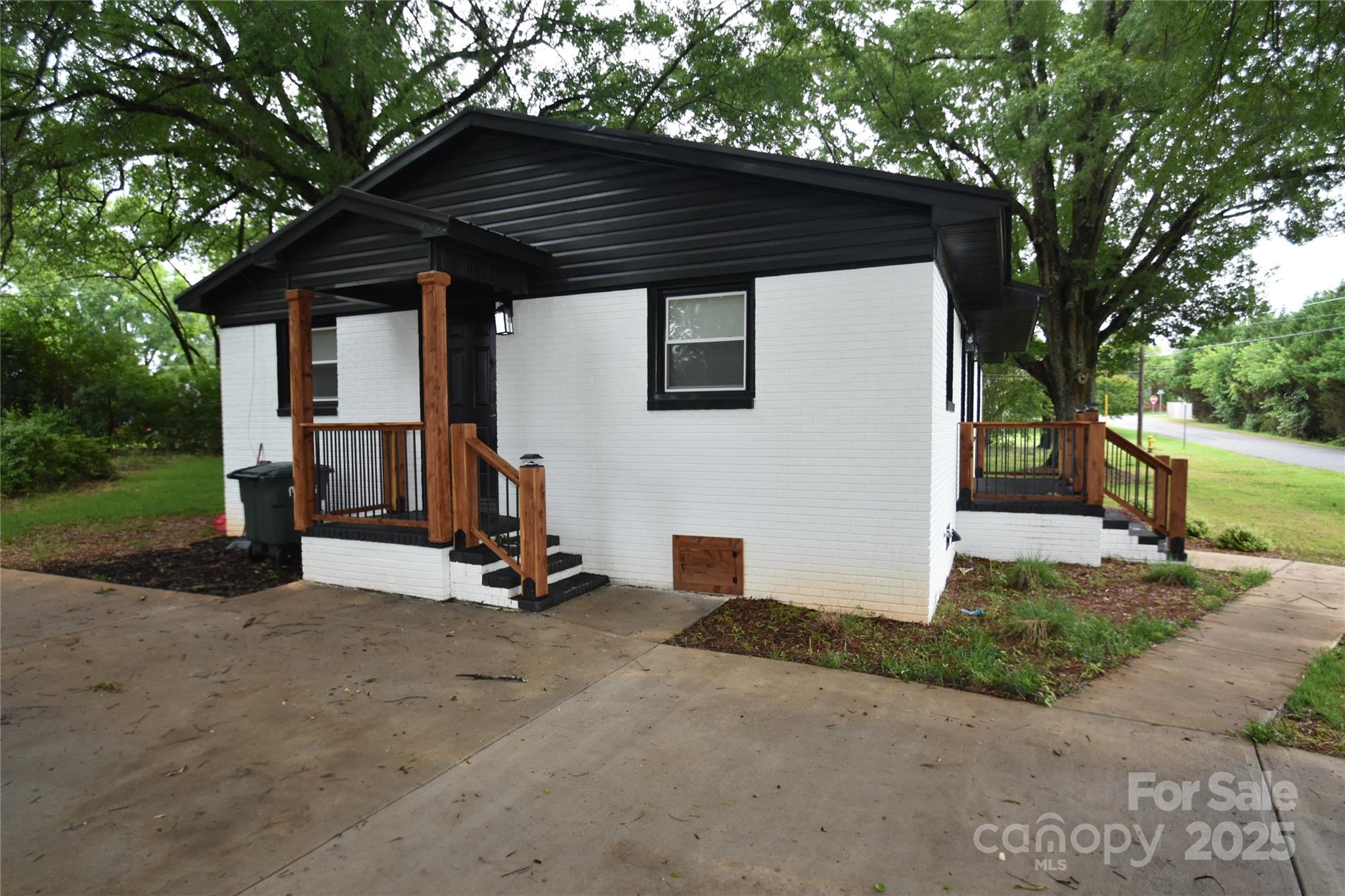 706 McIntyre Street Monroe, NC 28110 - Photo 4 of 20 a view of a barn with a small yard and large trees