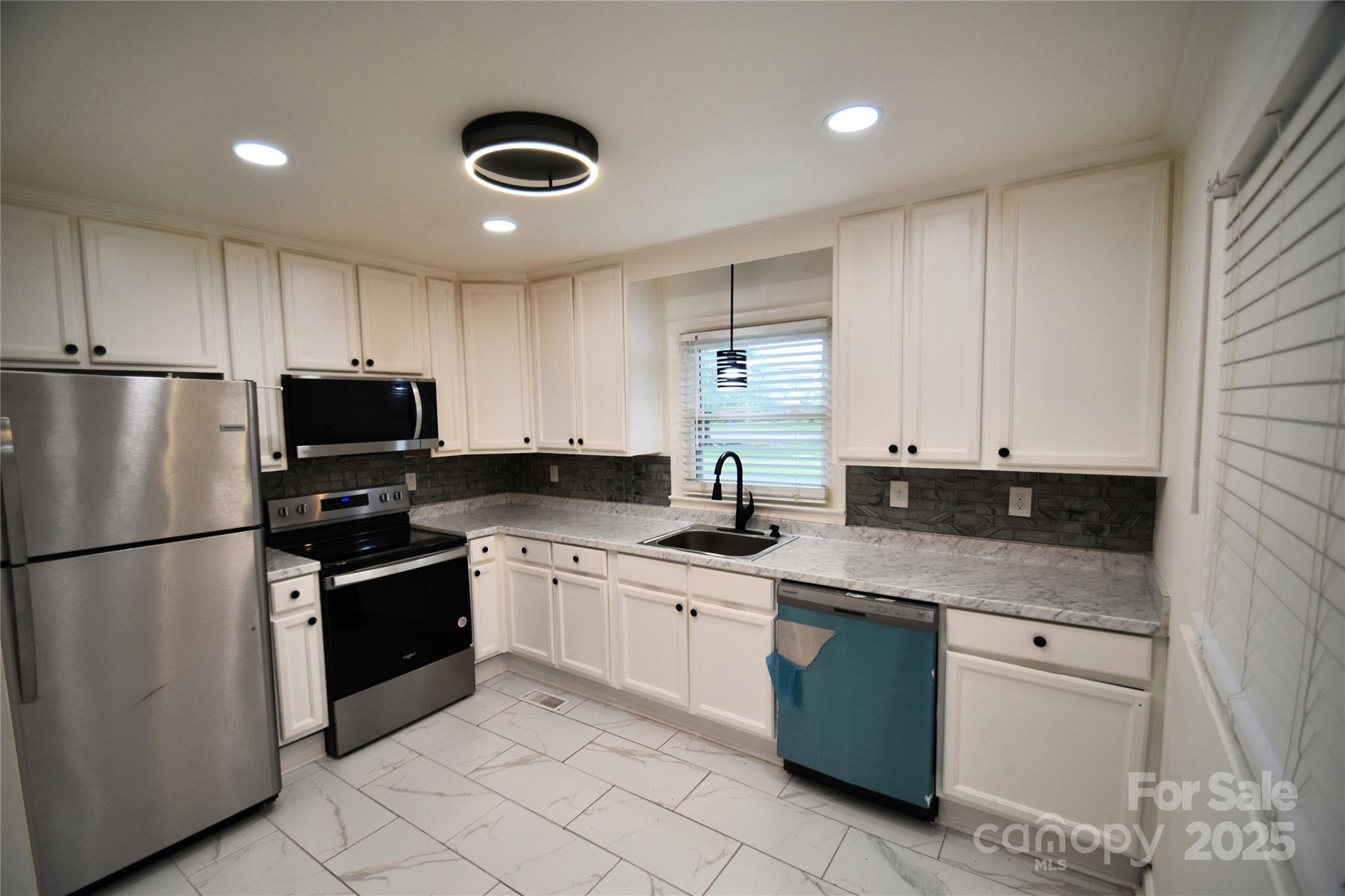 706 McIntyre Street Monroe, NC 28110 - Photo 8 of 20 a kitchen with granite countertop stainless steel appliances and white cabinets