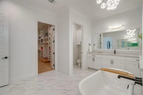 a spacious bathroom with a sink and a mirror