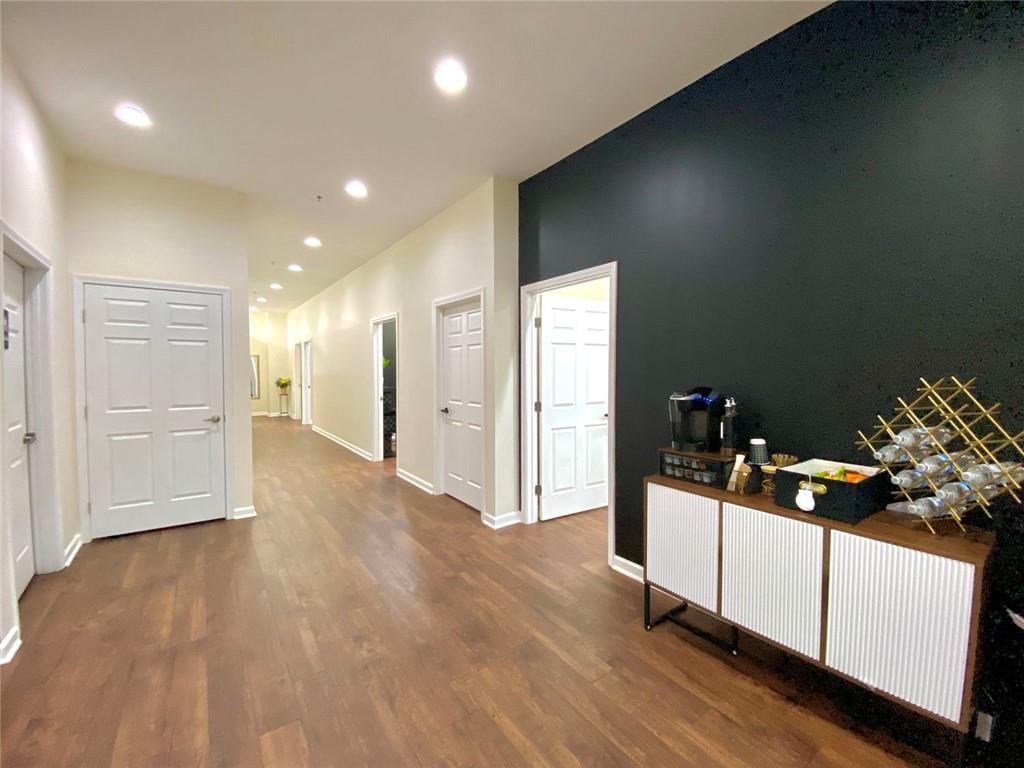 3636 Highlands Parkway Southeast, Unit 4 Smyrna, GA 30082 - Photo 12 of 32 a view of a hallway and a room with wooden floor