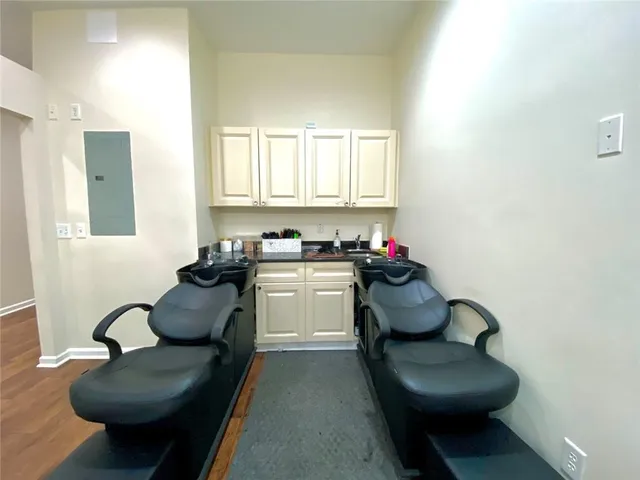 a living room with furniture chess board and a window