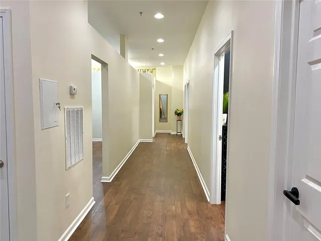 a view of a hallway with wooden floor