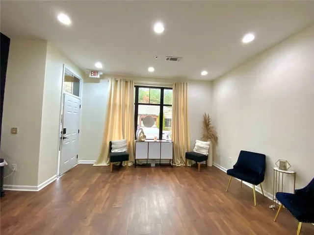 a living room with a hard wood floor and a window
