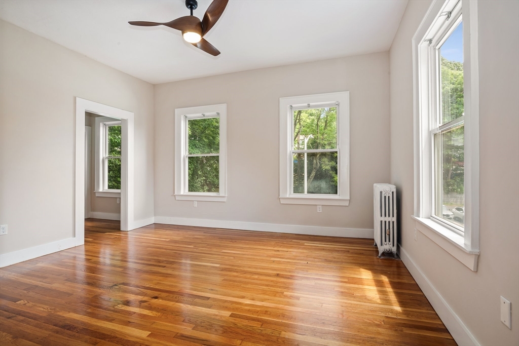 35 Oak Avenue, Unit 2 Worcester, MA 01605 - Photo 13 of 22 a view of an empty room with wooden floor and a window
