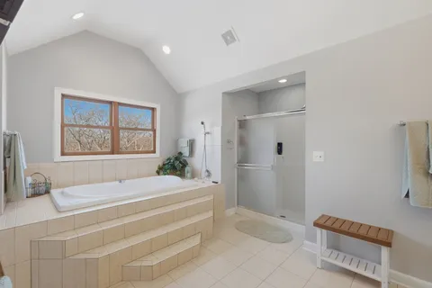 a spacious bedroom with a bed and a window