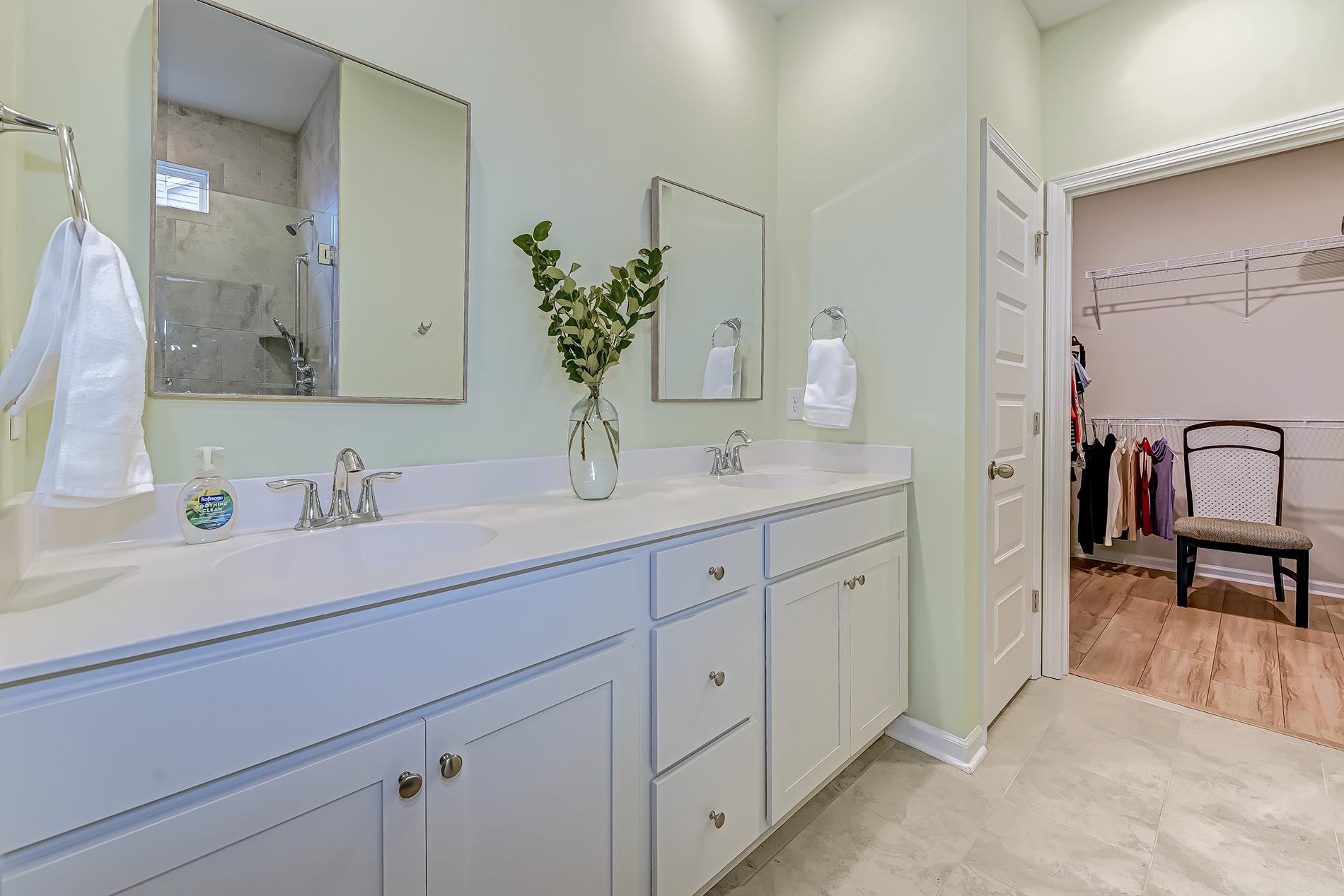 3016 Sistine Street Myrtle Beach, SC 29579 - Photo 17 of 39 Bathroom with double vanity, a spacious closet, and a tile shower