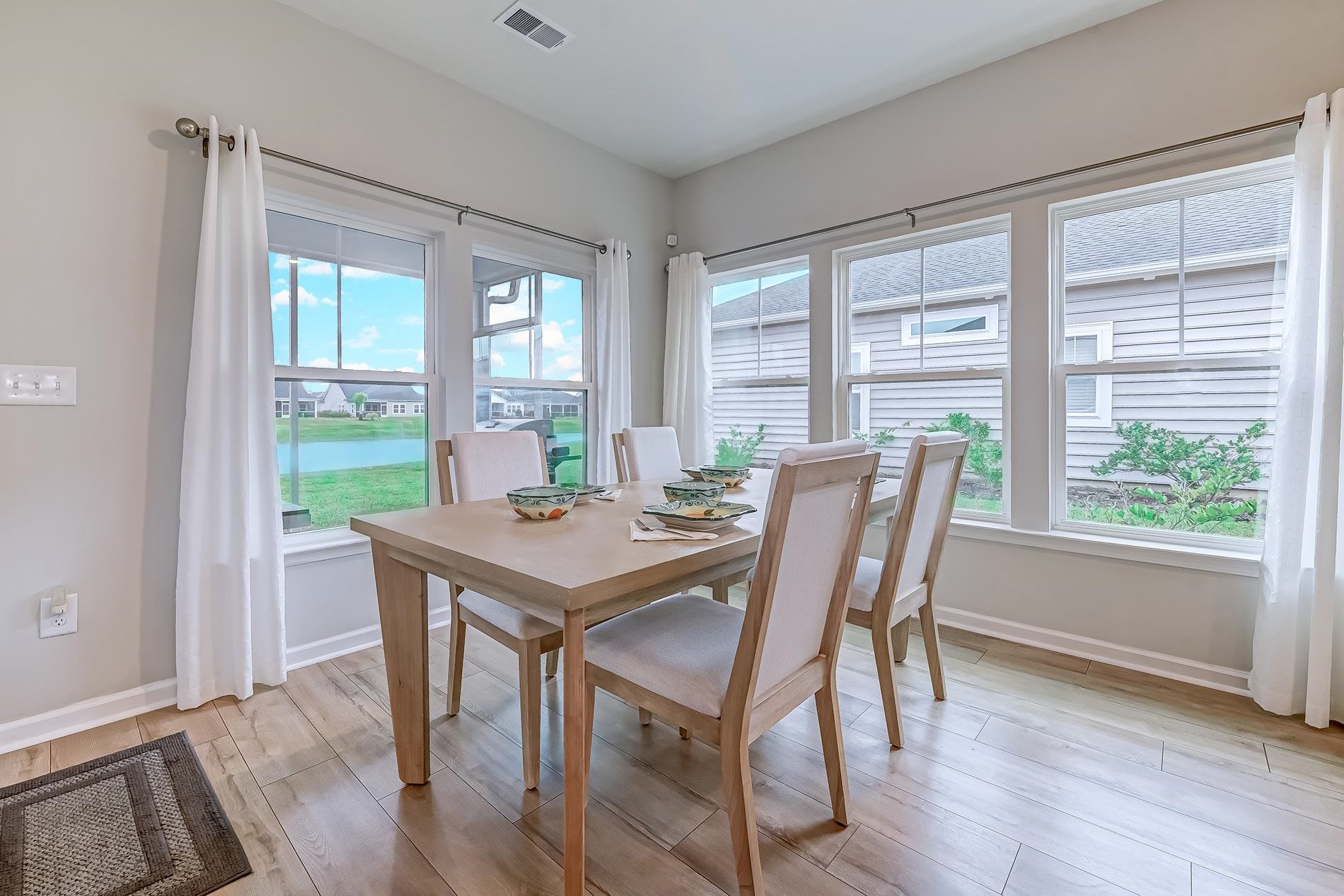 3016 Sistine Street Myrtle Beach, SC 29579 - Photo 27 of 39 Dining room featuring light wood-style flooring and a water view