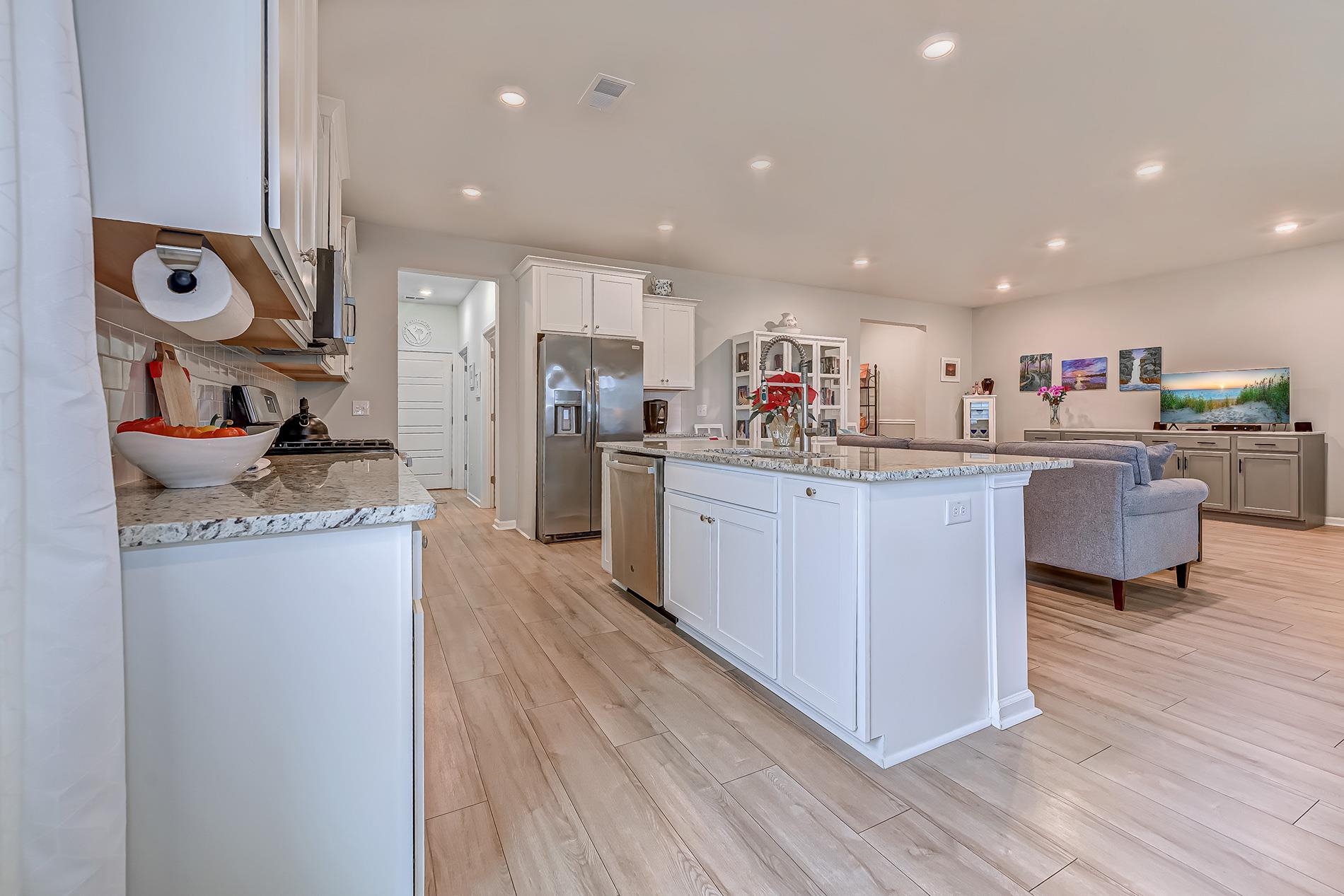 3016 Sistine Street Myrtle Beach, SC 29579 - Photo 39 of 39 Kitchen with light stone counters, open floor plan, light wood-style flooring, white cabinetry, and recessed lighting