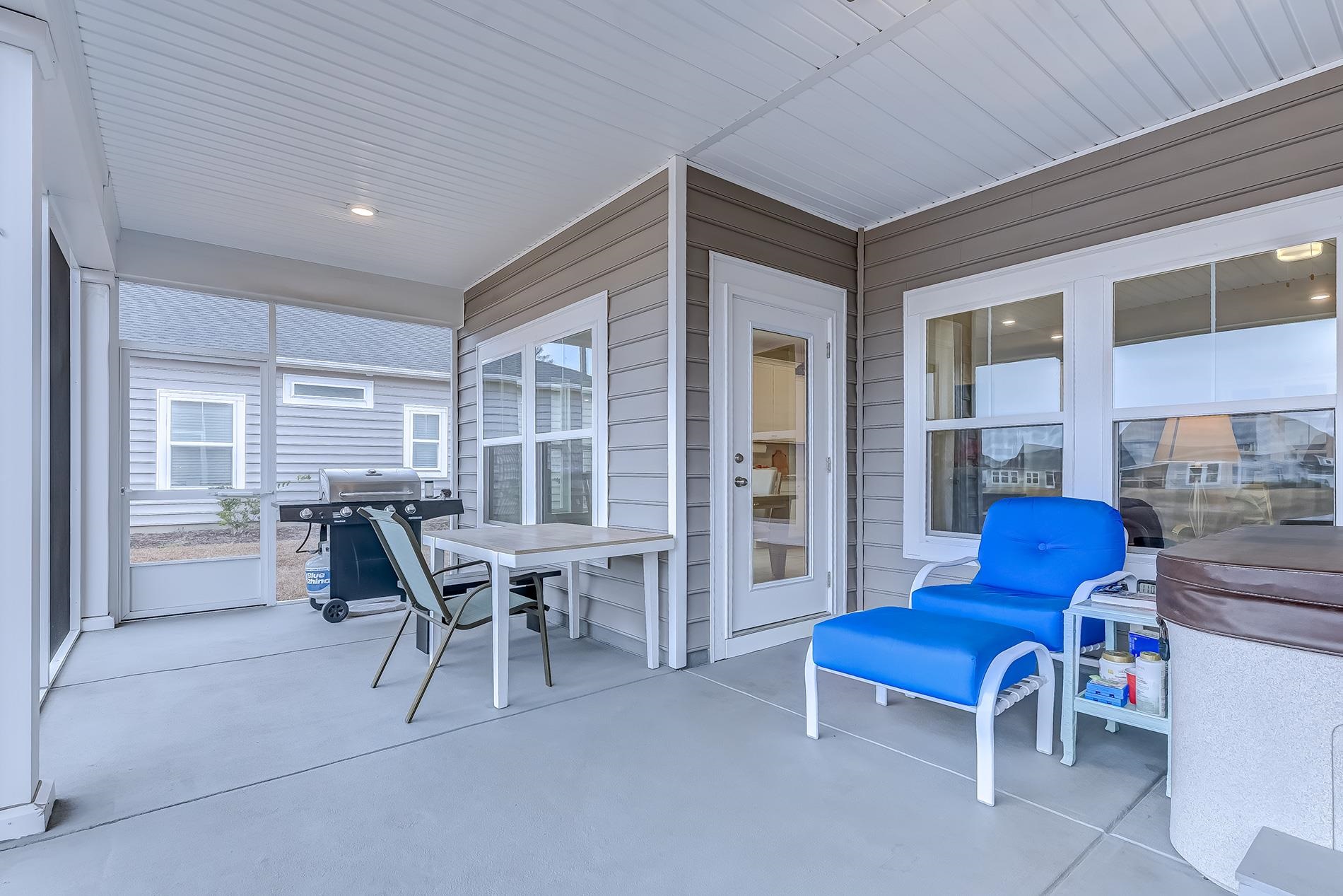 3016 Sistine Street Myrtle Beach, SC 29579 - Photo 34 of 39 Sunroom with finished concrete floors, a patio, and wood walls