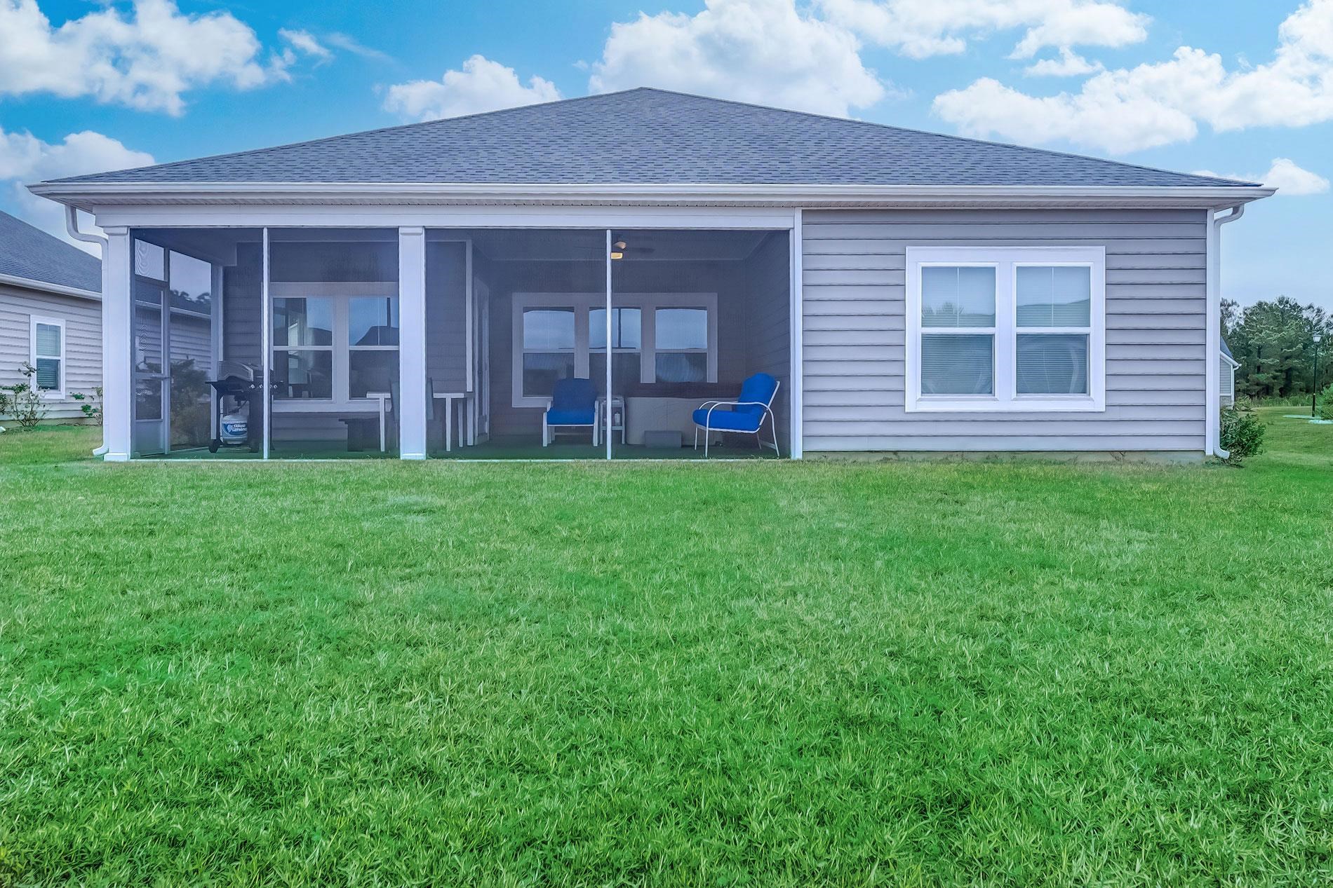 3016 Sistine Street Myrtle Beach, SC 29579 - Photo 36 of 39 Rear view of house with a shingled roof, a lawn, and a sunroom