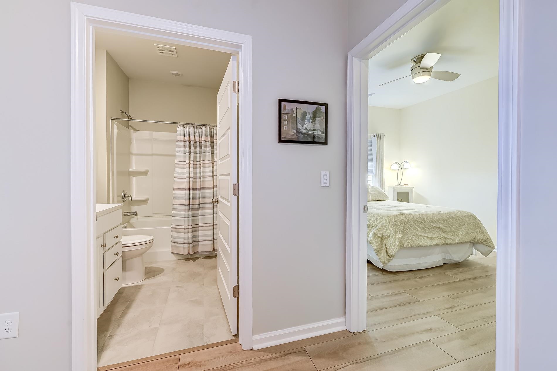 3016 Sistine Street Myrtle Beach, SC 29579 - Photo 6 of 39 Full bath featuring shower / tub combo with curtain, vanity, light wood-style flooring, a ceiling fan, and ensuite bathroom