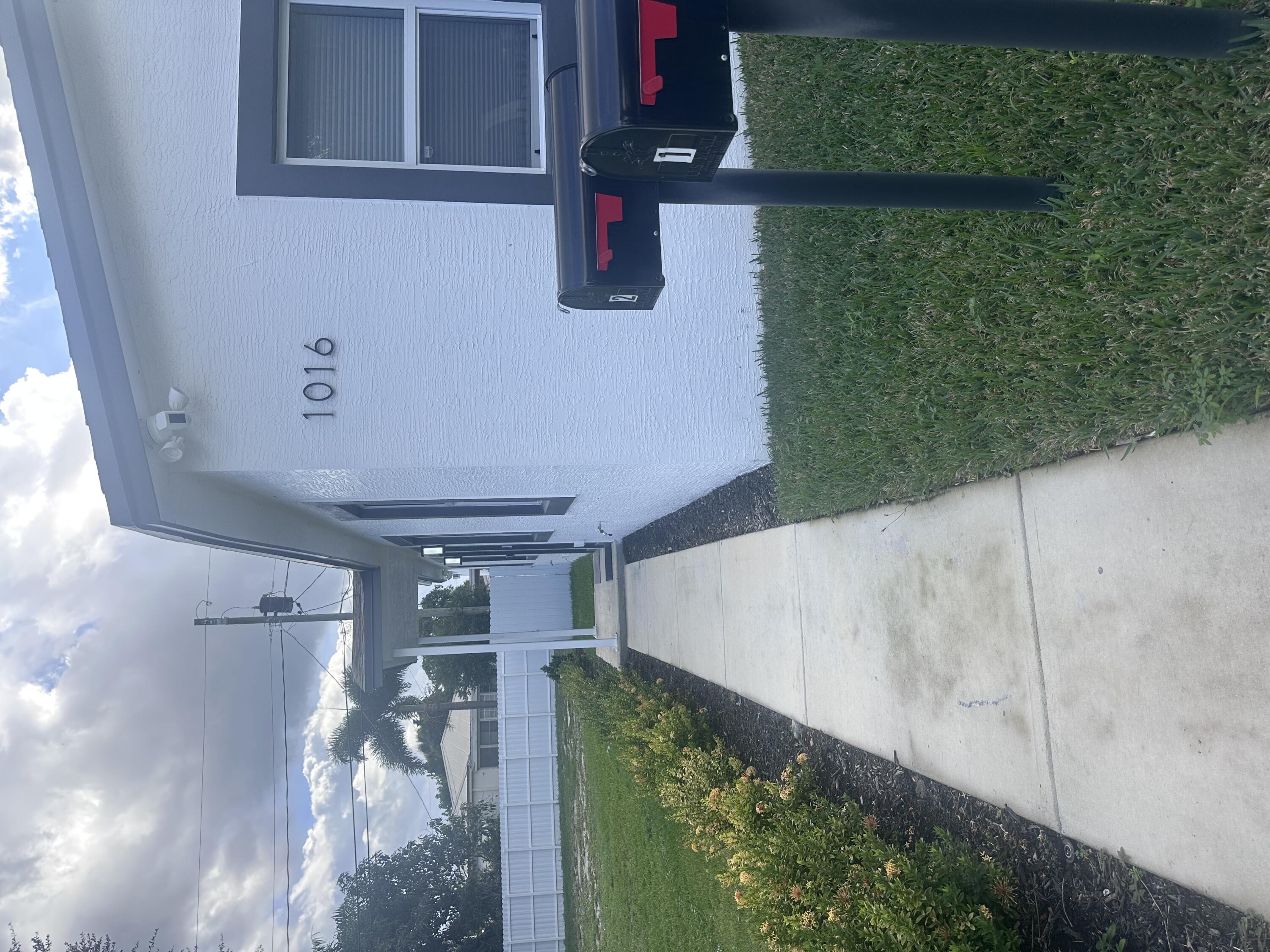 1016 State Street, Unit 12 West Palm Beach, FL 33407 - Photo 1 of 13 a view of a backyard with pathway