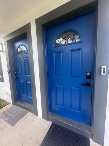 an empty room with wooden floor cabinet and mirror