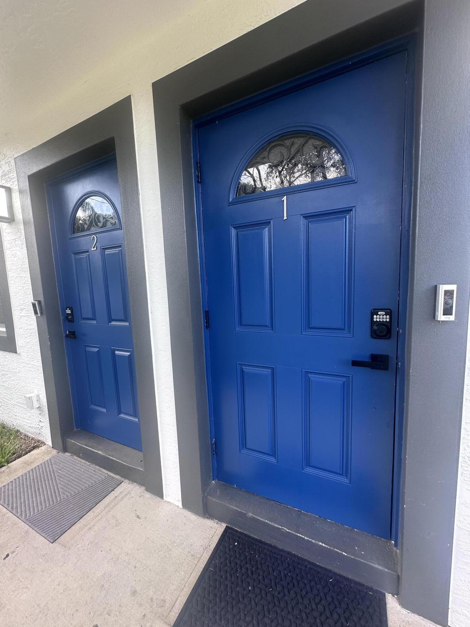 1016 State Street, Unit 12 West Palm Beach, FL 33407 - Photo 11 of 13 an empty room with wooden floor cabinet and mirror