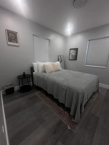 a bedroom with a bed and a night stand