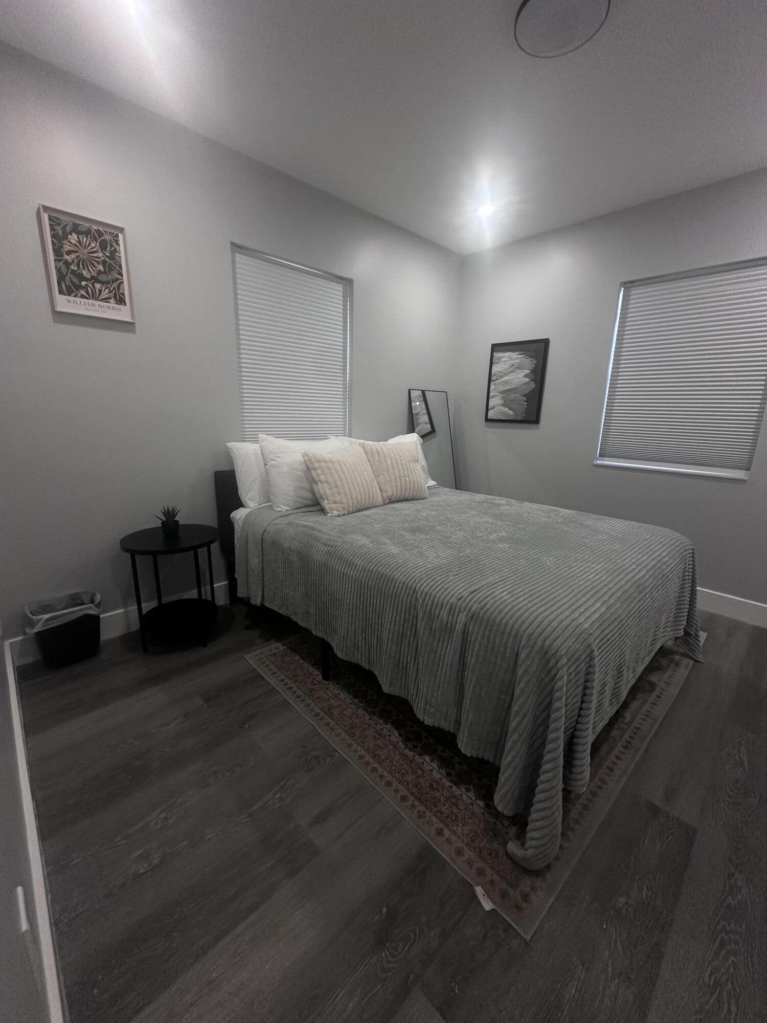 1016 State Street, Unit 12 West Palm Beach, FL 33407 - Photo 4 of 13 a bedroom with a bed and a night stand