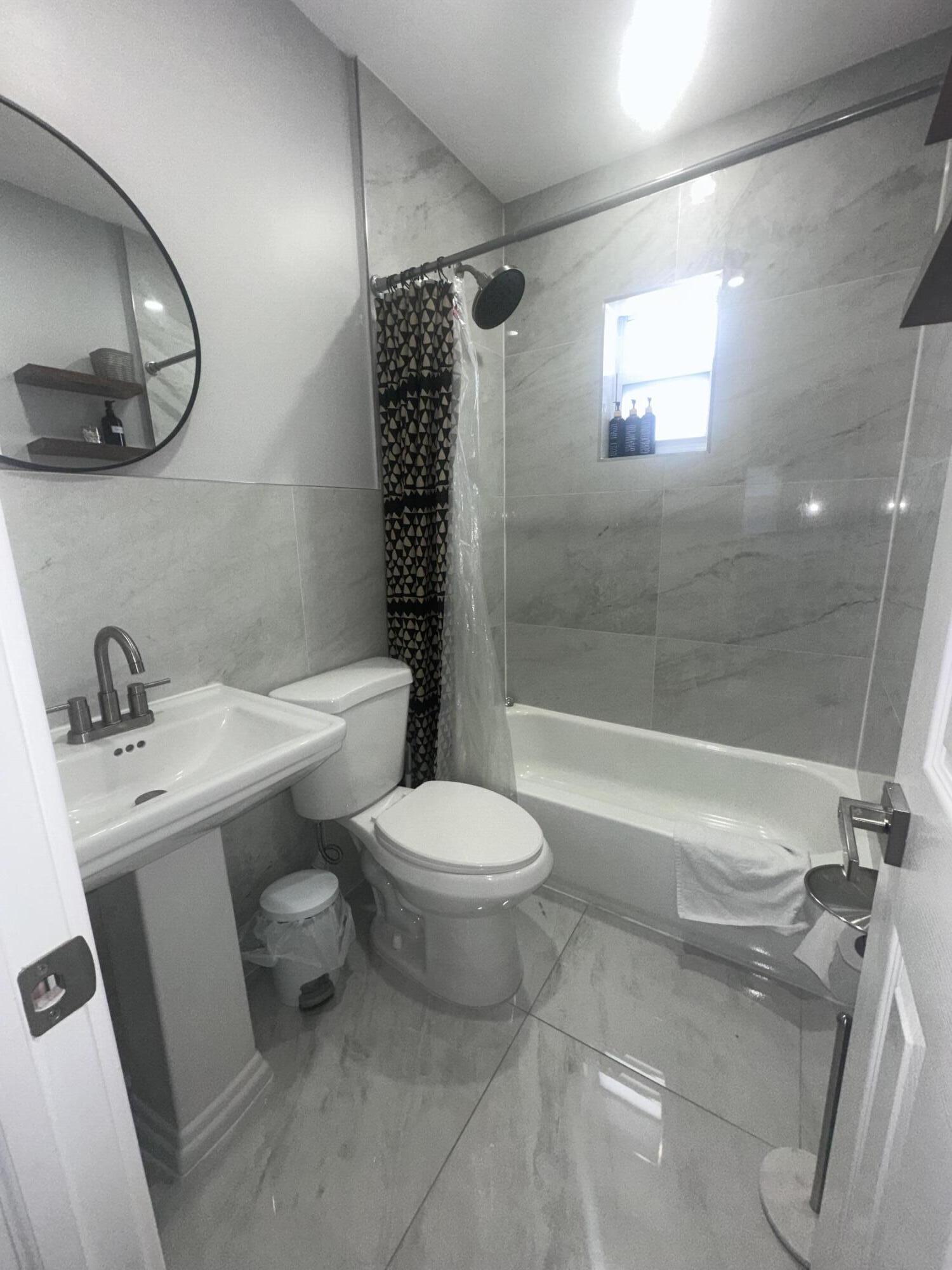 1016 State Street, Unit 12 West Palm Beach, FL 33407 - Photo 6 of 13 a bathroom with a sink toilet and shower