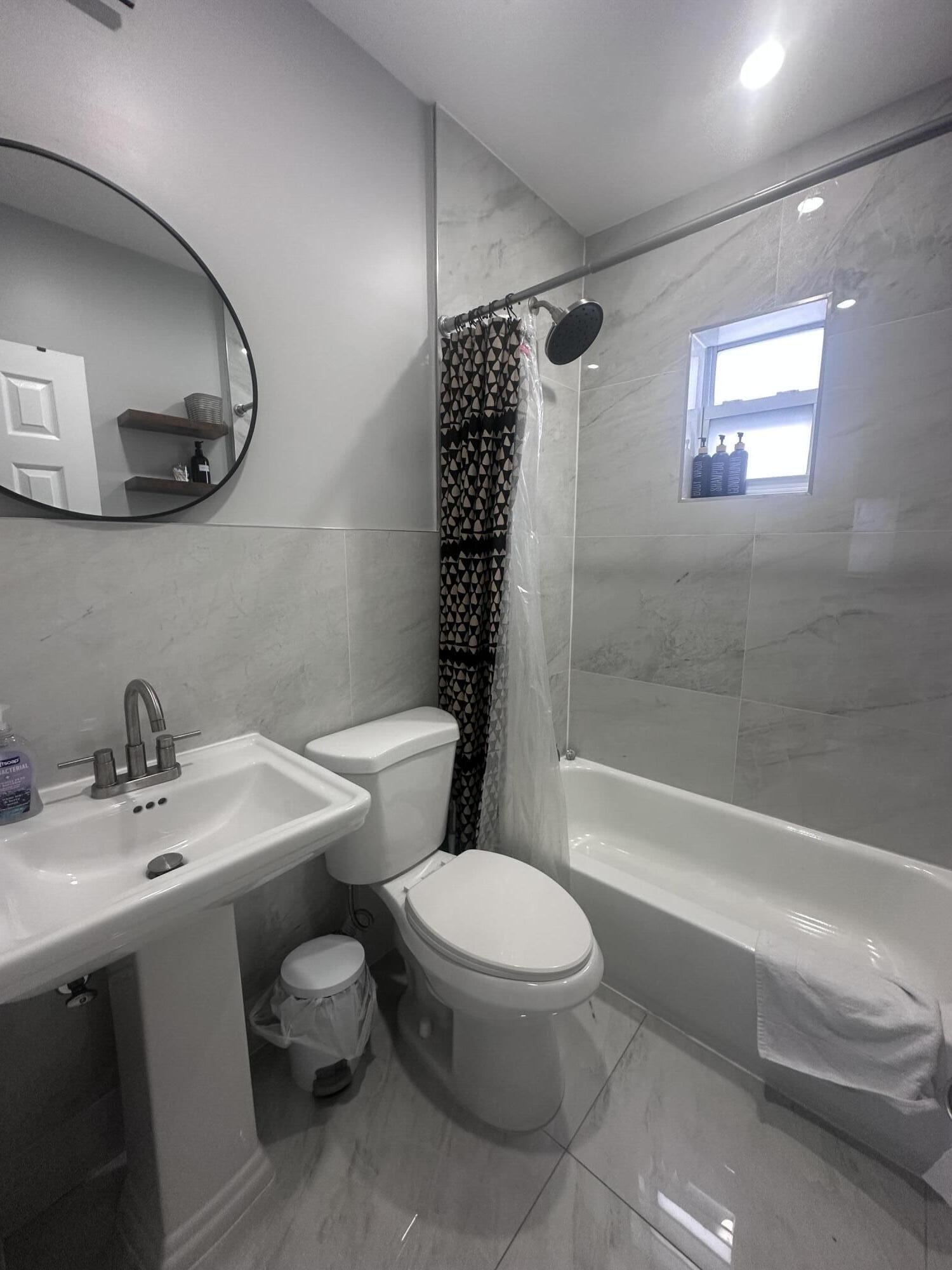 1016 State Street, Unit 12 West Palm Beach, FL 33407 - Photo 7 of 13 a bathroom with a sink a toilet and shower