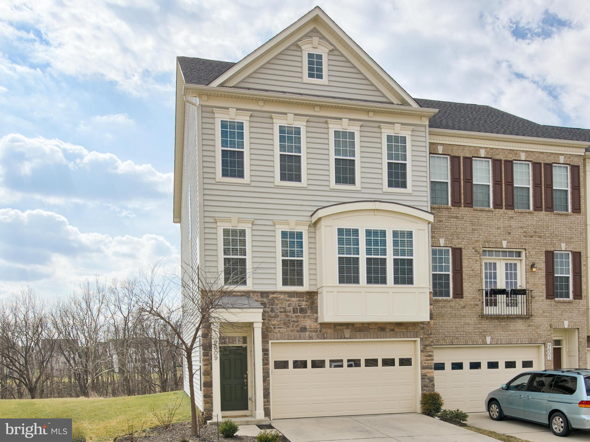 a front view of a residential apartment building with a yard