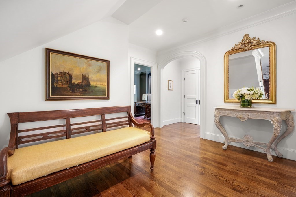 111 Lake Street Sherborn, MA 01770 - Photo 14 of 41 a hallway with a bench and paintings on the wall