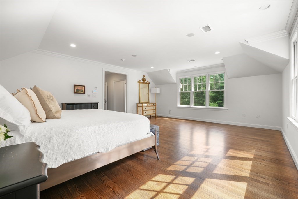 111 Lake Street Sherborn, MA 01770 - Photo 19 of 41 a large bed sitting in a bedroom next to a window and a chandelier