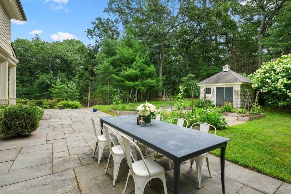 111 Lake Street Sherborn, MA 01770 - Photo 36 of 41 a backyard of a house with table and chairs