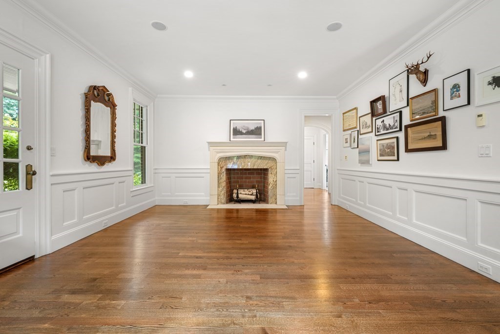 111 Lake Street Sherborn, MA 01770 - Photo 4 of 41 a view of a livingroom with a fireplace a ceiling fan and wooden floor