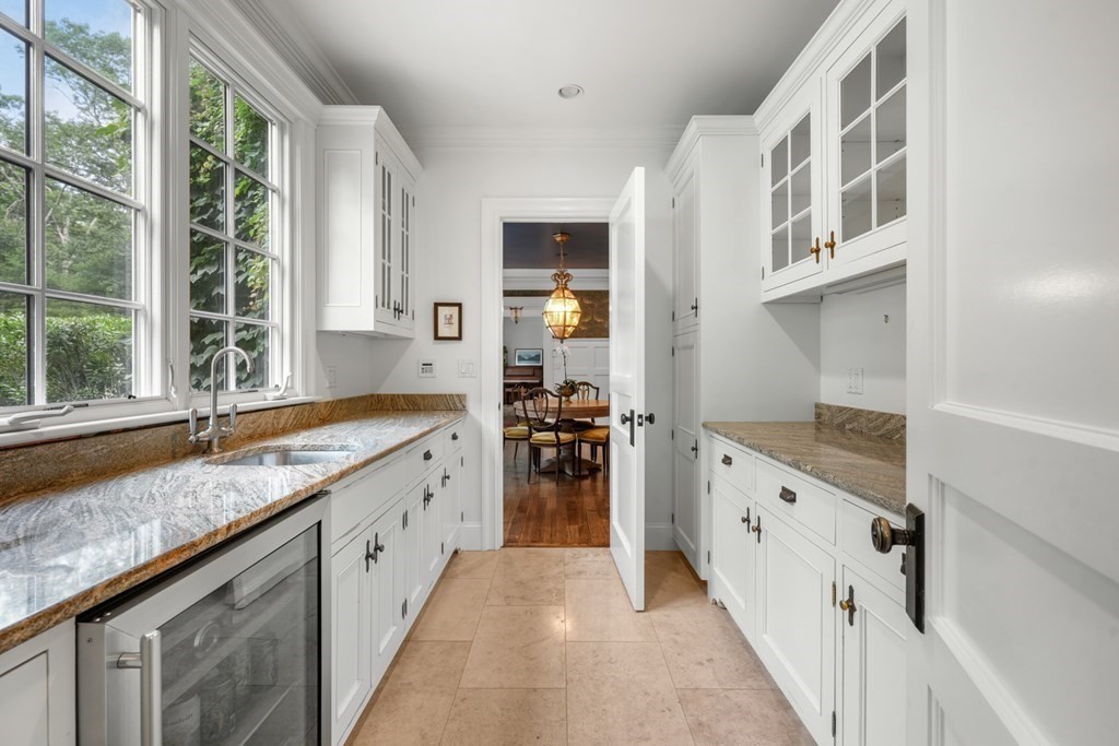 111 Lake Street Sherborn, MA 01770 - Photo 6 of 41 a large white kitchen with granite countertop a sink and dishwasher next to a large window