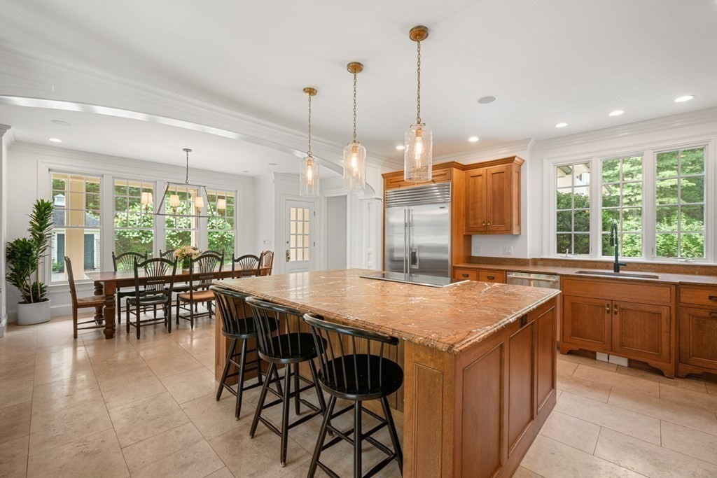 111 Lake Street Sherborn, MA 01770 - Photo 9 of 41 a kitchen with stainless steel appliances granite countertop table chairs and wooden cabinets