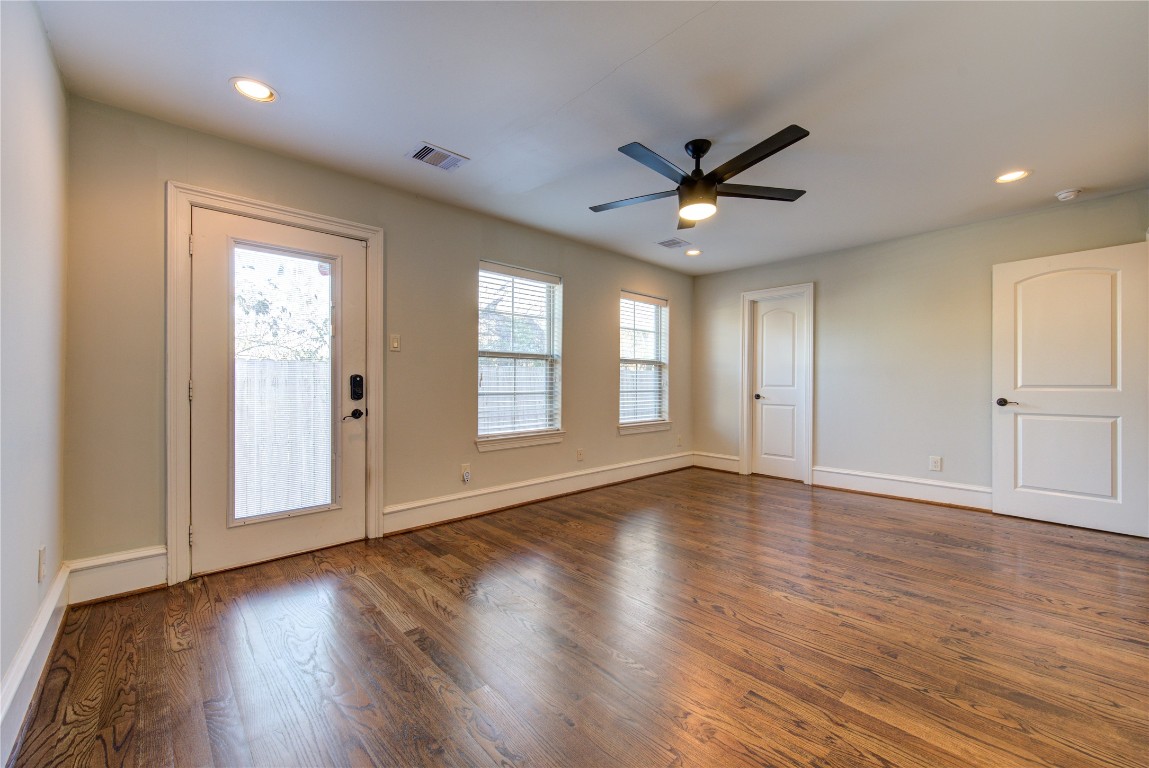 5226 Kiam Street, Unit 1015 Houston, TX 77007 - Photo 12 of 49 a view of an empty room with a window and wooden floor