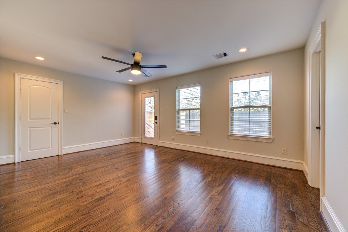 5226 Kiam Street, Unit 1015 Houston, TX 77007 - Photo 15 of 49 a view of an empty room with wooden floor and a window