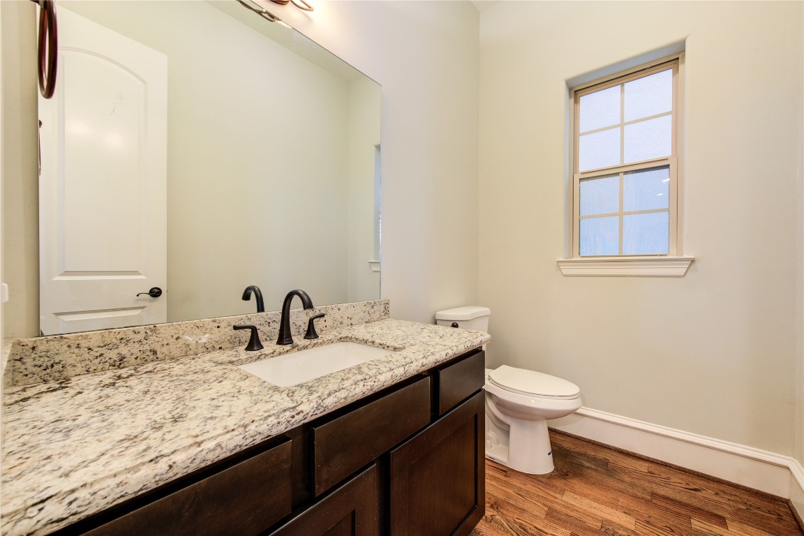 5226 Kiam Street, Unit 1015 Houston, TX 77007 - Photo 18 of 49 a bathroom with a granite countertop sink and a toilet