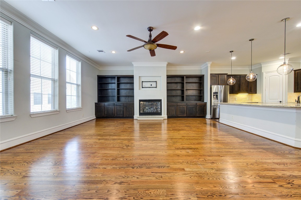 5226 Kiam Street, Unit 1015 Houston, TX 77007 - Photo 19 of 49 a view of a living room with hardwood floor and a ceiling fan