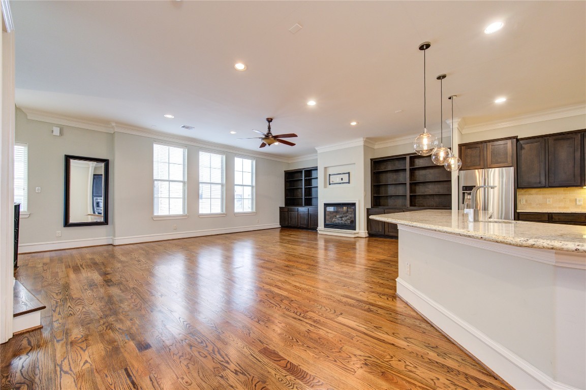 5226 Kiam Street, Unit 1015 Houston, TX 77007 - Photo 23 of 49 a view of a kitchen with kitchen island a counter top space appliances and a ceiling fan